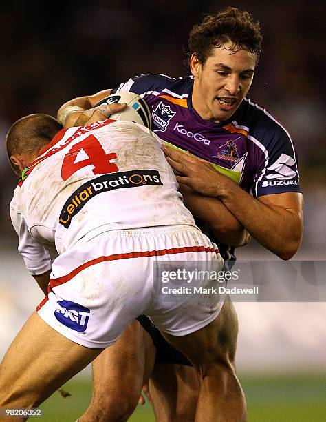 Billy Slater of the Storm is tackled by Matt Cooper of the Dragons during the round four NRL match between the Melbourne Storm and the St George...