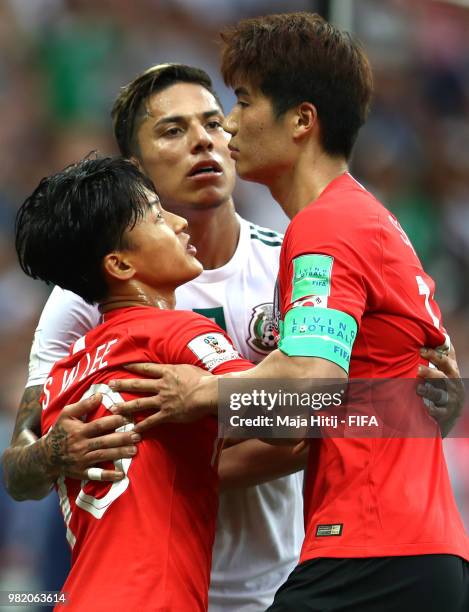 Carlos Salcedo of Mexico argues wth Ki Sung-Yueng and Lee Seung-Woo of Korea Republic during the 2018 FIFA World Cup Russia group F match between...