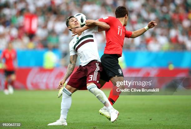 Carlos Salcedo of Mexico is tcakled by Hwang Hee-chan of Korea Republic during the 2018 FIFA World Cup Russia group F match between Korea Republic...