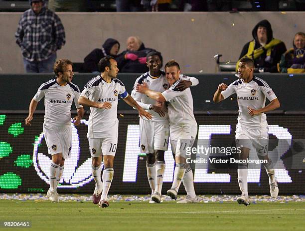 Edson Buddle of the Los Angeles Galaxy celebrates his second half goal and second goal of the game with teammates Chris Birchall, Landon Donovan,...