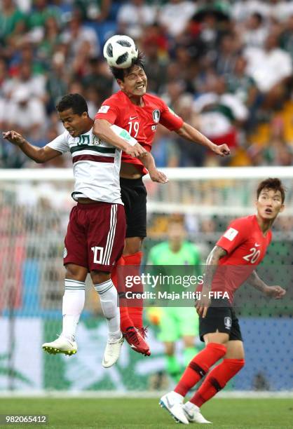 Giovani Dos Santos of Mexico competes for a header with Younggwon Kim of Korea Republic during the 2018 FIFA World Cup Russia group F match between...