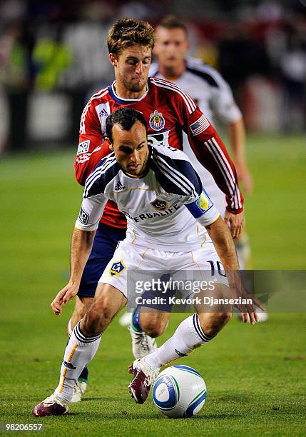 Landon Donovan of the Los Angeles Galaxy controls the ball against Blair Gavin of Chivas USA during the second half of the MLS soccer match on April...