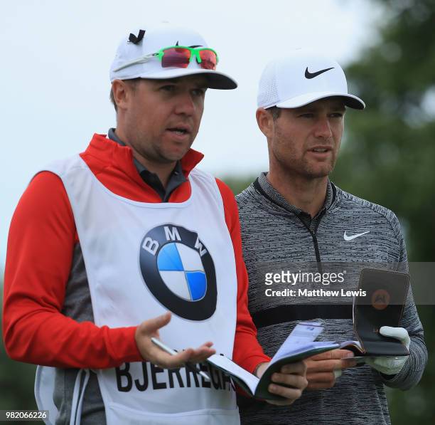 Lucas Bjerregaard of Denmark looks on with his caddie during day three of the BMW International Open at Golf Club Gut Larchenhof on June 23, 2018 in...