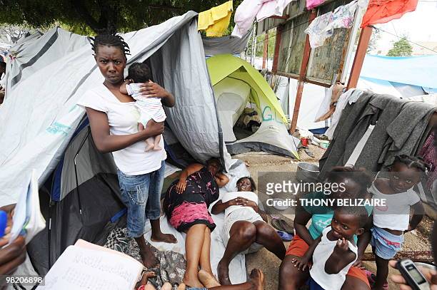 Women and children are seen on April 01, 2010 in a tent city of Petion-Ville, a neighborhood of Port-au-Prince. The global community has pledged...