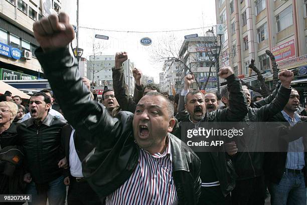 Turkish workers of the state tobacco company TEKEL who were protesting against layoffs and the government's labor policy, shout anti-government...