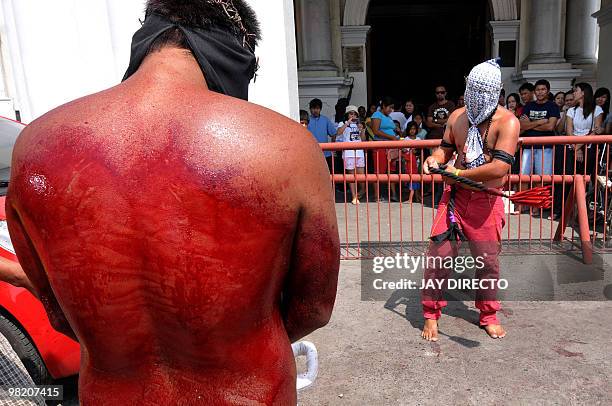 Filipino Roman Catholic devotee flagellates himself themselves during a ritual for Holy Week on the run up to Easter in San Fernando, north of...