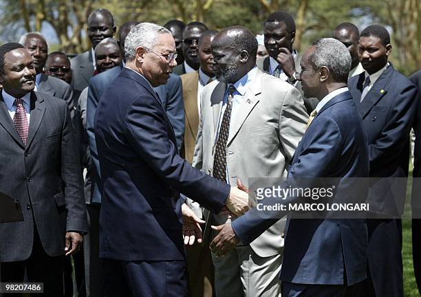 Secretary of State Colin Powell shakes hands, 22 October 2003 at the end of his press briefing in Naivasha, Kenya, with Sudan First Vice Presidend...