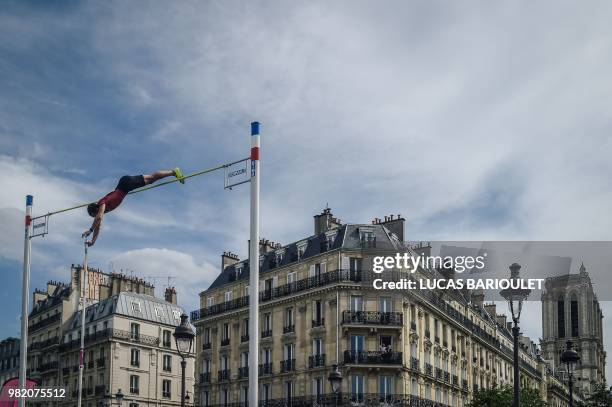 French pole vaulter Rene Lavillenie perform in front of the public on the Pont d'Arcole in the center of Paris during the "Olympics Day" organized by...