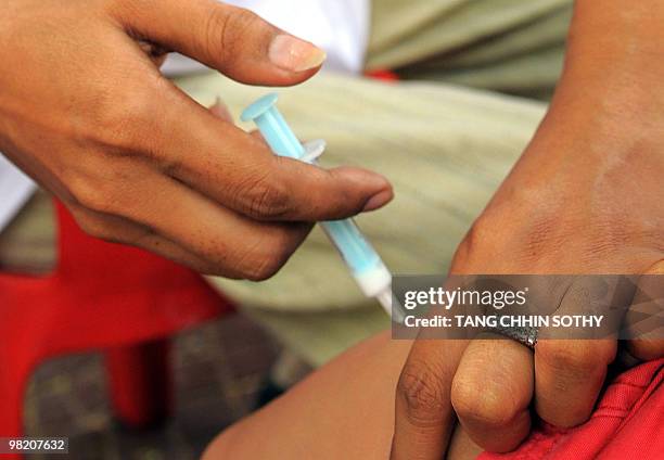 Cambodian child receives a vaccine for A-H1N1 along a street in Phnom Penh on April 1, 2010. The Ministry of Health started on March 24 its national...