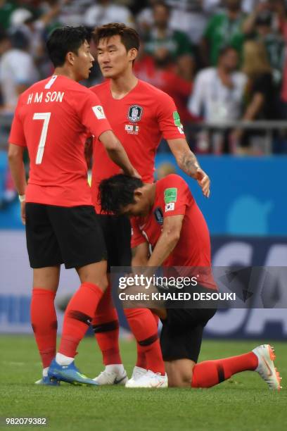 South Korea's forward Son Heung-min , South Korea's midfielder Lee Jae-sung and South Korea's defender Jang Hyun-soo react after the final whistle of...