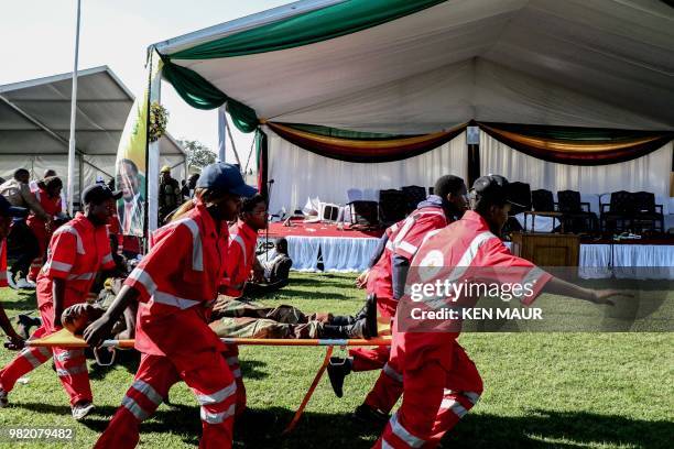 Injured people are evacuated after an explosion at the stadium in Bulawayo where Zimbabwe President just addressed a rally on June 23, 2018. An AFP...