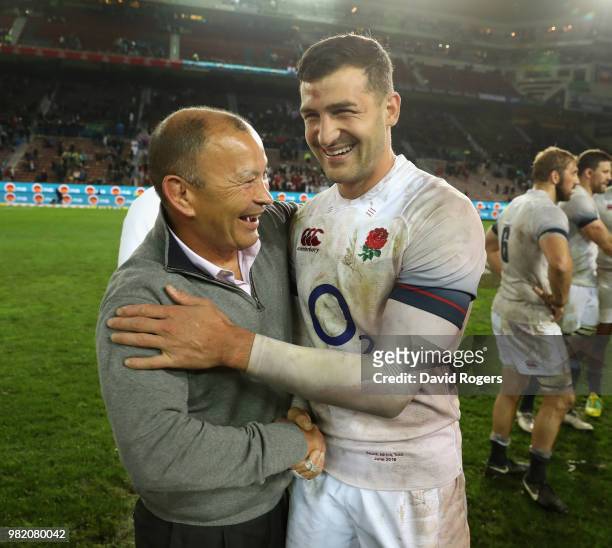 Eddie Jones, the England head coach celebrates wtih try scorer Jonny May after their victory during the third test match between South Africa and...