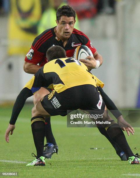 Dan Carter of the Crusaders is tackled by Andre Taylor of the Hurricanes during the round eight Super 14 match between the Hurricanes and the...