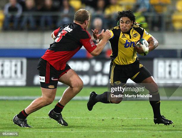 Ma'a Nonu of the Hurricanes fends off Owen Franks of the Crusaders during the round eight Super 14 match between the Hurricanes and the Crusaders at...