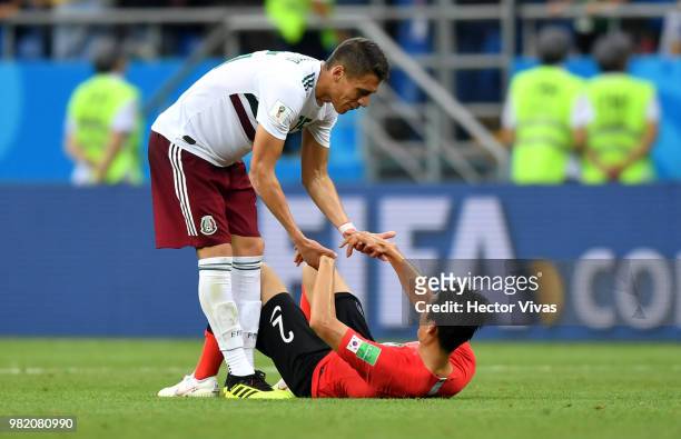 Hector Moreno of Mexico helps up Yong Lee of Korea Republic during the 2018 FIFA World Cup Russia group F match between Korea Republic and Mexico at...
