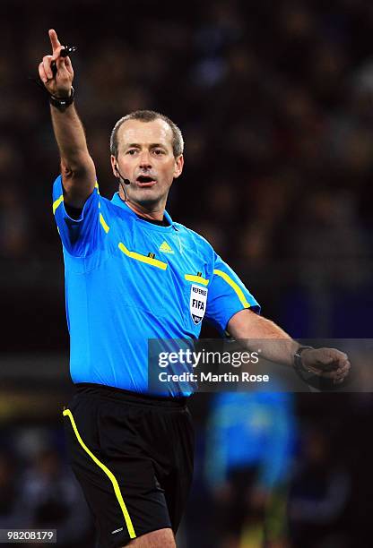 Referee Martin Atkinson makes a point during the UEFA Europa League quarter final first leg match between Hamburger SV and Standard Liege at HSH...