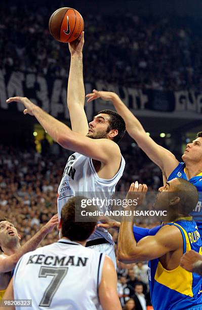 Slavko Vranes of Partizan Belgrade shoots the ball over Maccabi Tel Aviv players during their teams fourth Euroleague quarterfinal match in Belgrade...