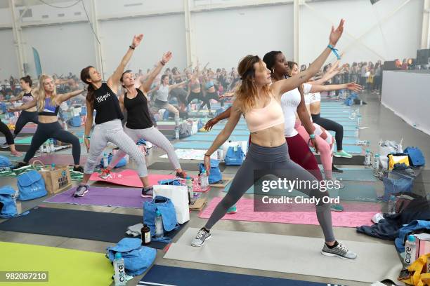 Guests do yoga at the Studio Tone It Up Live! at Duggal Greenhouse on June 23, 2018 in Brooklyn, New York.