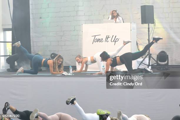 Co-founders, Tone It Up Katrina Scott and Karena Dawn lead yoga with Josephine Skriver on stage at the Studio Tone It Up Live! at Duggal Greenhouse...