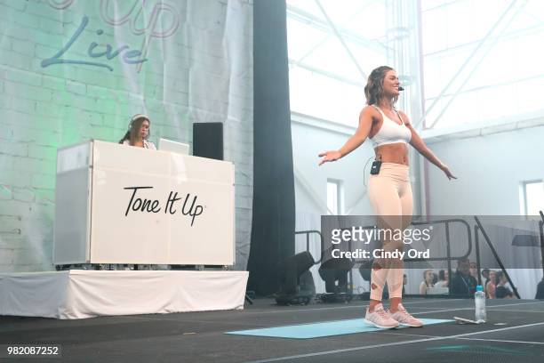 Tori Simeone leads yoga on stage at the Studio Tone It Up Live! at Duggal Greenhouse on June 23, 2018 in Brooklyn, New York.