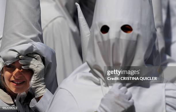 Penitents take part in the 'La Paz' brotherhood procession during the Holy Week in Seville on March 28, 2010. Christian believers around the world...