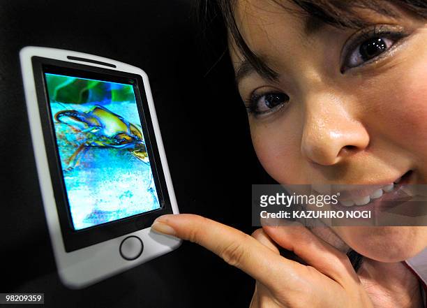 Model displays a 3D touchscreen LCD developed by Japan's Sharp Co., featuring the company's highest brightness that can switch between 2D and 3D...