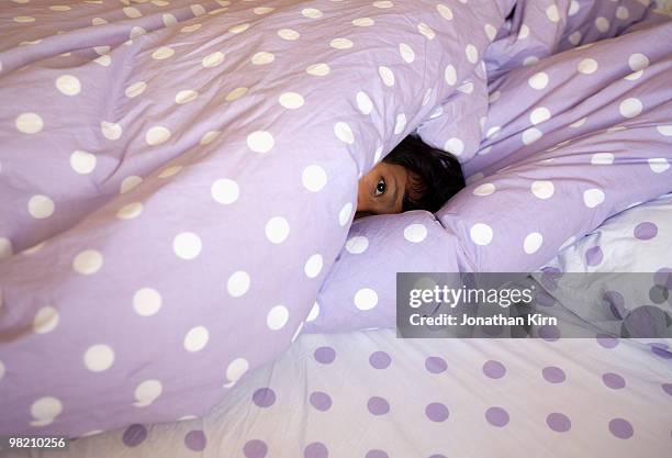 dreamy eyed girl in bed.  - beds dreaming children stock pictures, royalty-free photos & images