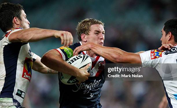 Mitchell Aubusson of the Roosters is tackled during the round four NRL match between the Sydney Roosters and the Brisbane Broncos at Sydney Football...