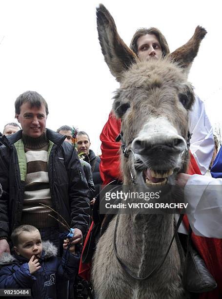 Catholic Belarussian impersonating Jesus Christ rides a donkey during a procession celebrating Palm Sunday in Minsk on March 28, 2010. Palm Sunday...