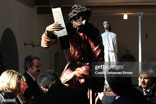 Wooden sculptures, depicting Jesus Christ are brought back into the church after a Good Friday procession on April 2, 2010 in Lohr am Main, Germany....