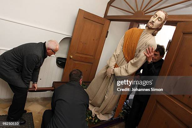 Wooden sculptures, depicting Jesus Christ are brought back into the church after a Good Friday procession on April 2, 2010 in Lohr am Main, Germany....