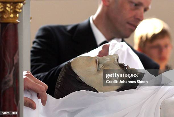 Wooden sculptures, depicting Jesus Christ are brought back into the church after a Good Friday procession on April 2, 2010 in Lohr am Main, Germany....
