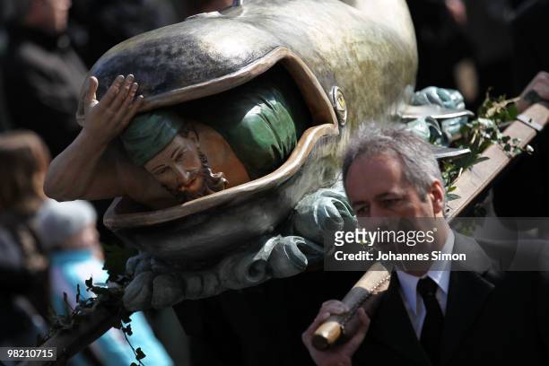 Catholic believers carry a wodden sculpture during a Good Friday procession on April 2, 2010 in Lohr am Main, Germany. Several thousands of faithful...