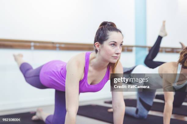 multiethnic group of women work out together in a modern health club - pike position stock pictures, royalty-free photos & images