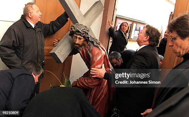 Wooden sculptures, depicting Jesus Christ are brought back into the church after a Good Friday procession on April 2, 2010 in Lohr am Main, Germany....