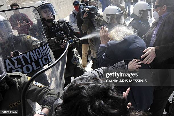 Manolis Glezos , Greek left wing politician and writer, known especially for his participation in the World War II resistance, is attacked by riot...