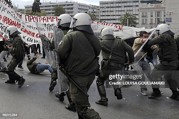 Demonstrators clash with police outside the Greek parliament in Athens on March 5, 2010. Greek police fired tear gas and clashed with protesters...