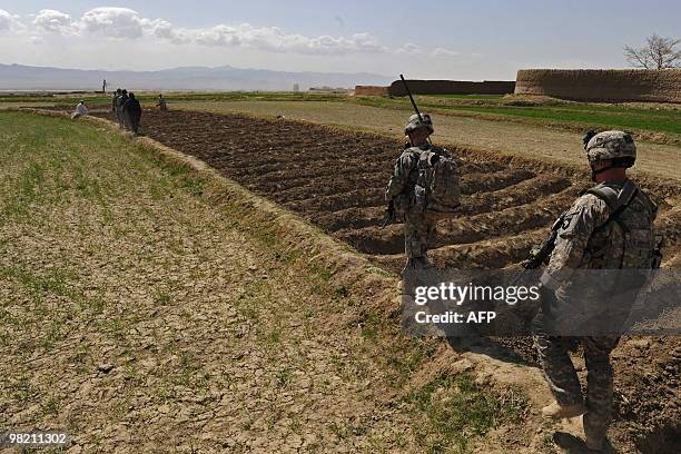 Army soldiers from 1st Platoon Alpha company 3-187 3BCT 101 Airborne walk to inform farmers about an IED they discovered on a main road in Yosef Khel...