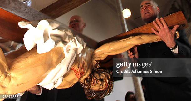 Wooden sculptures, depicting Jesus Christ are brought back into the church after a Good Friday procession on April 2, 2010 in Lohr am Main, Germany....