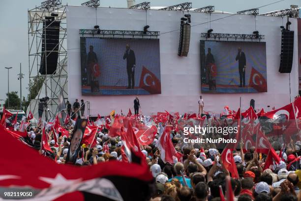 Supporters wave flags and cheer while listening to Muharrem Ince, presidential candidate of Turkey's main opposition Republican People's Party speak...