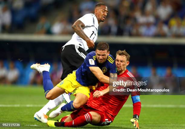 Marcus Berg of Sweden goes down in the penalty area under challenge from Jerome Boateng and Manuel Neuer during the 2018 FIFA World Cup Russia group...