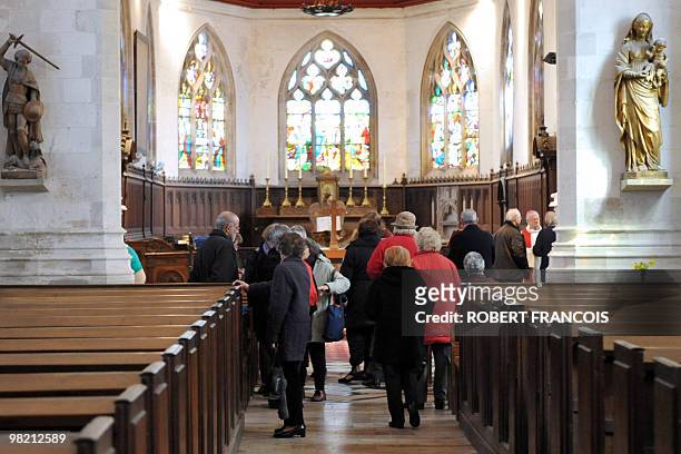 People walk in the Saint-Martin de Canteleu church, in Canteleu, northern France, on April 2, 2010. A French Catholic priest has admitted sexually...