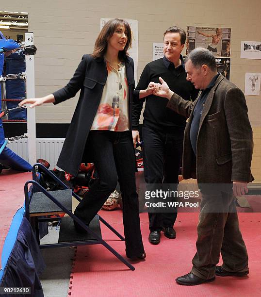 Conservative Party Leader David Cameron his wife Samantha Cameron and boxing club secretary Patrick Sands during a visit to the Pedro Club in Hackney...