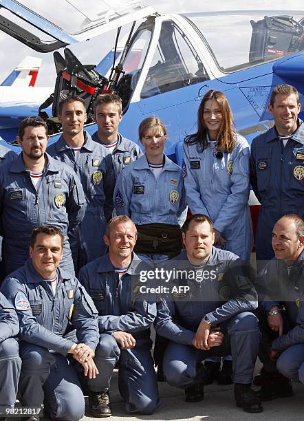 France's first lady Carla Bruni-Sarkozy patron of the French aerobatic squadron "Patrouille de France" poses with its leader Captain Virginie Guyot...