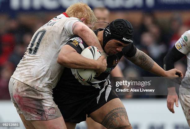 Iafeta Palea'aesina of Wigan Warriors is tackled by James Graham of St. Helens during the Engage Super League match between St. Helens and Wigan...