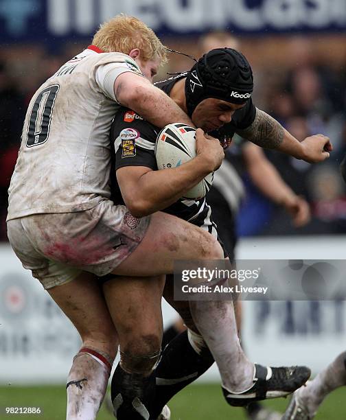 Iafeta Palea'aesina of Wigan Warriors is tackled by James Graham of St. Helens during the Engage Super League match between St. Helens and Wigan...