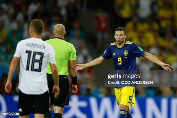 Sweden's forward Marcus Berg gestures as he speaks with Polish referee Szymon Marciniak after failing to score during the Russia 2018 World Cup Group...