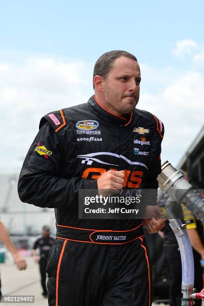 Johnny Sauter, driver of the ISM Connect Chevrolet, runs through the garage during practice for the NASCAR Camping World Truck Series Villa Lighting...