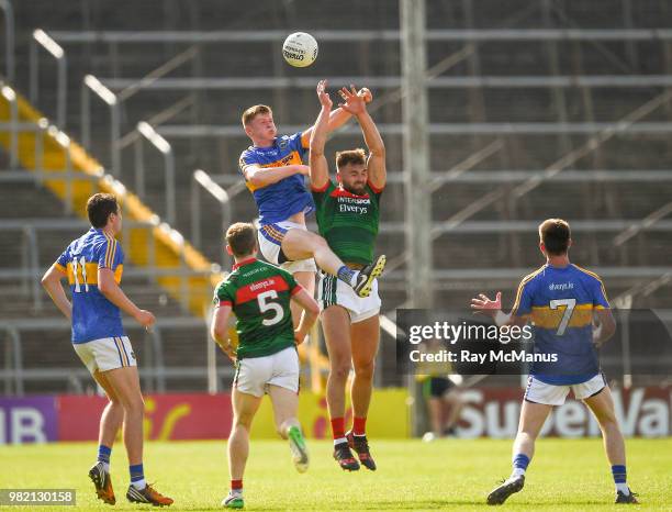 Tipperary , Ireland - 23 June 2018; John Meagher of Tipperary and Aidan O'Shea of Mayo jump highest in an effort to win possession during the GAA...