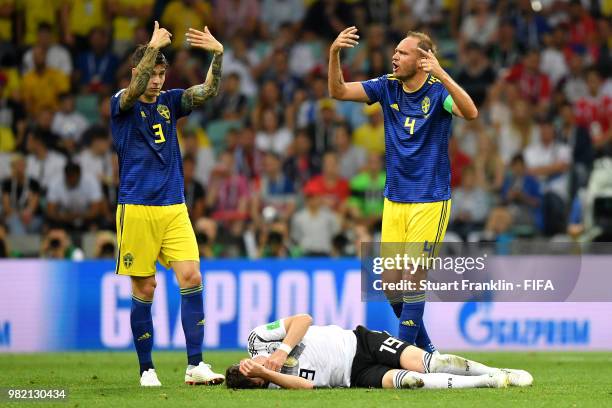 Victor Lindelof and Andreas Granqvist of Sweden call the medical staff as Sebastian Rudy of Germany lies on the pitch injured during the 2018 FIFA...